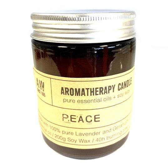 A jar of aromatherapy candles labelled "Peace," made from soy wax with lavender and geranium oils, promoting calm and clarity.