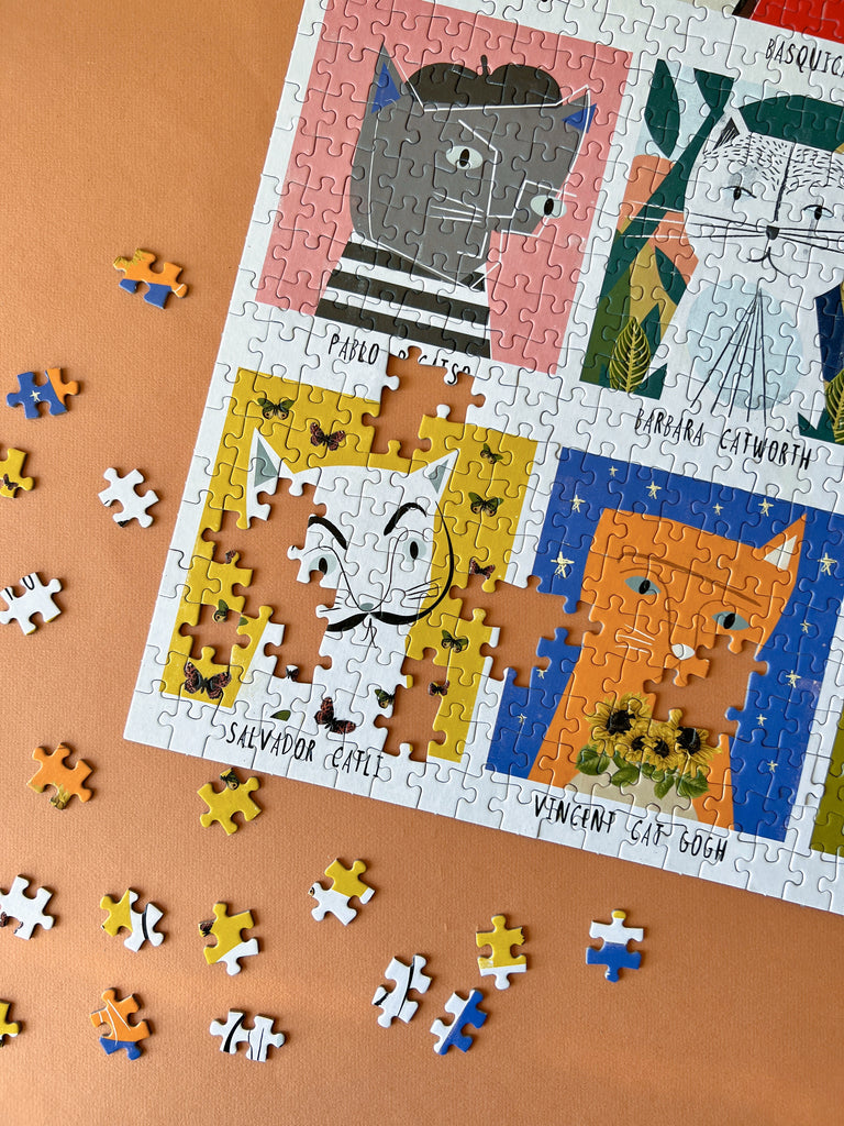 A colourful jigsaw puzzle featuring playful cats in various poses and patterns, ready to be assembled.