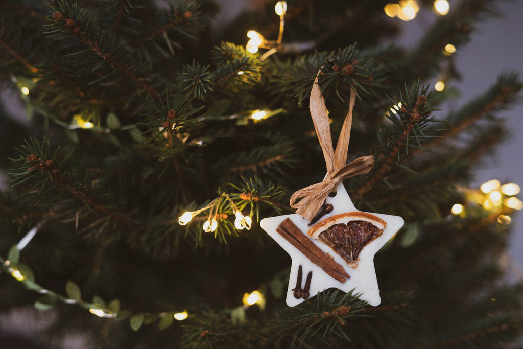 Christmas tree scented star decoration hanging on Christmas Tree with Christmas lighting