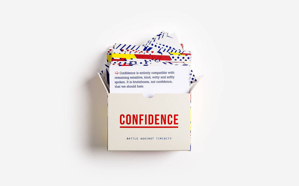 A colourful box for the "Confidence Game," containing various cards and game elements to encourage self-assurance and fun.
