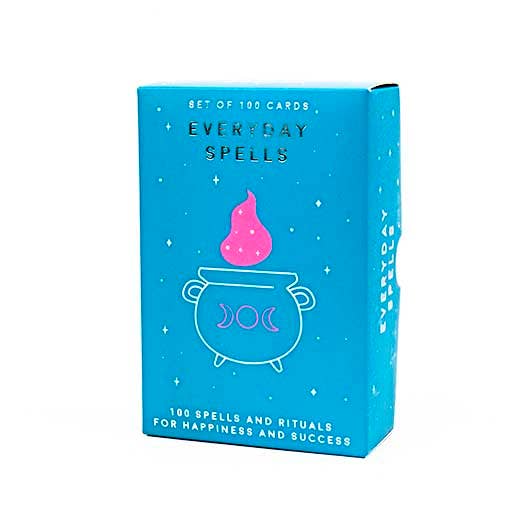 Front view of the blue packaging box of the Everyday Spells Cards which has a cauldron and pink flame on the front