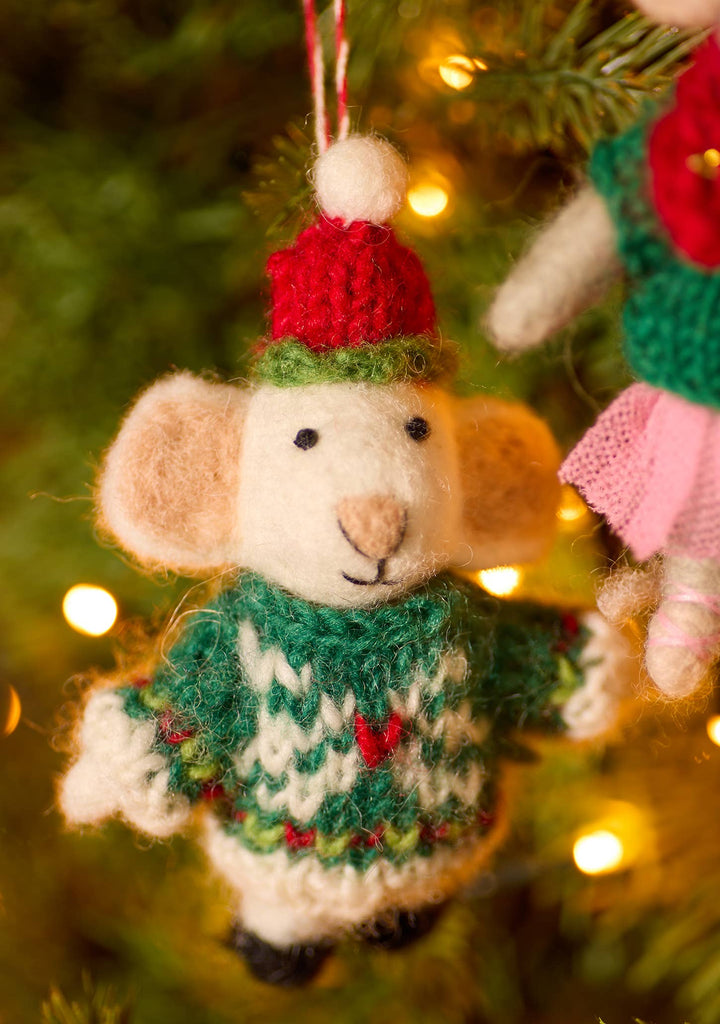 Mouse with festive hat and cozy jumper hang from a Christmas tree, adorned with red and white threads.