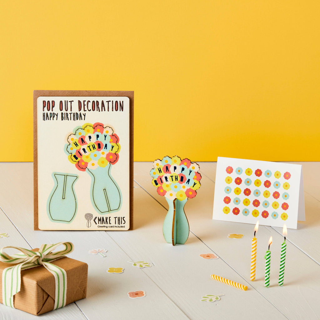 Happy birthday flowers wooden pop out card with turquoise vase and multi coloured flowers on a yellow birthday background with lit candles