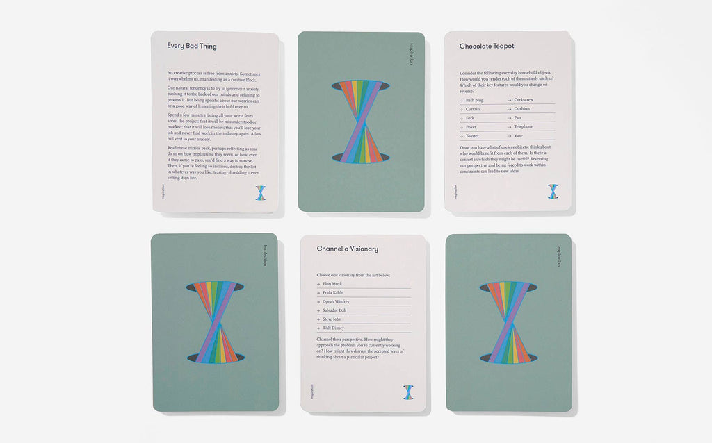 Four colourful cards featuring vibrant rainbow designs stacked together.