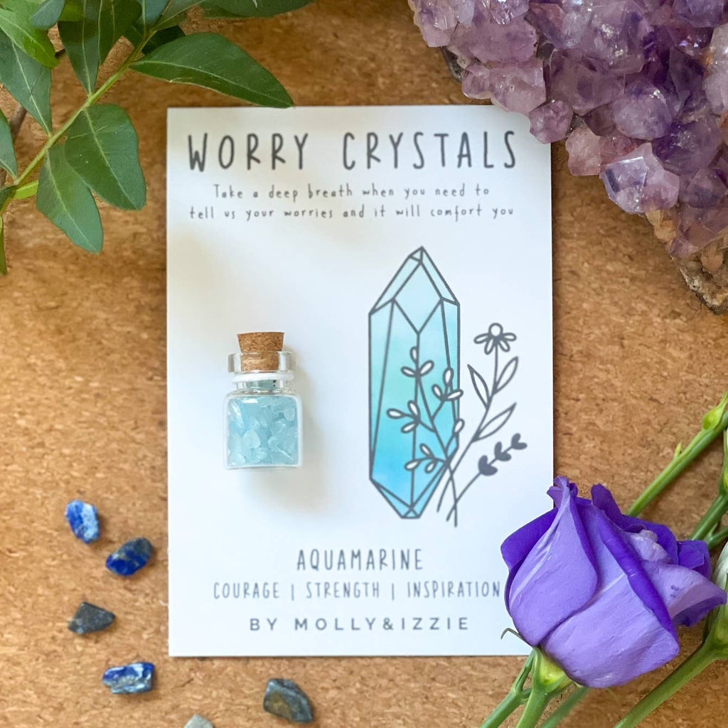 A woman displays a card with a crystal embedded in it, highlighting its unique shape and brilliance.