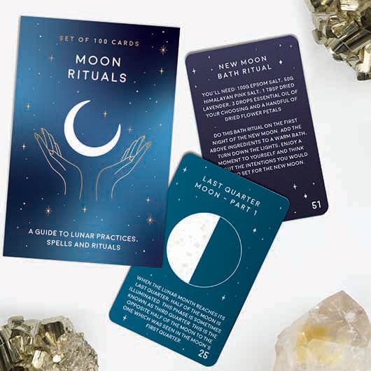 A moon rituals deck featuring cards, perfect for spiritual practices and enhancing lunar energy, surrounded by crystals.