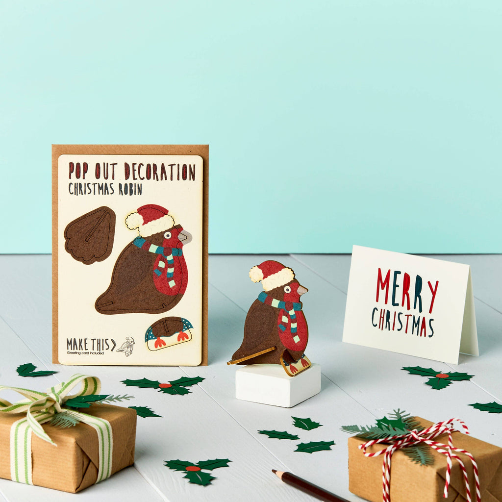 Robin Christmas Pop Out wooden card on a festive turquoise background with holly and festive wrapped presents