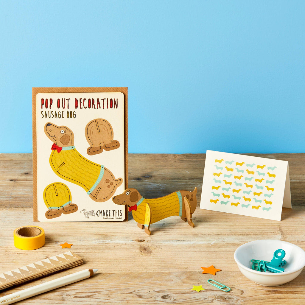 Sausage dog pop out wooden standing card on a blue background