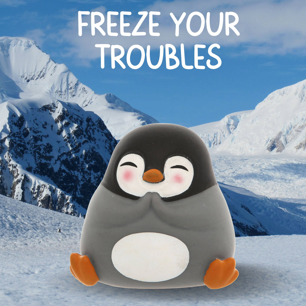 A solitary penguin perched on a snowy hill, accompanied by the text "freeze your troubles."