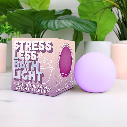A purple Stress Less Bath Light beside a box, designed for mindful colour-changing relaxation.