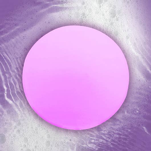 A purple ball suspended in a bubble of water, illustrating the relaxing ambiance of the Stress Less Bath Light.