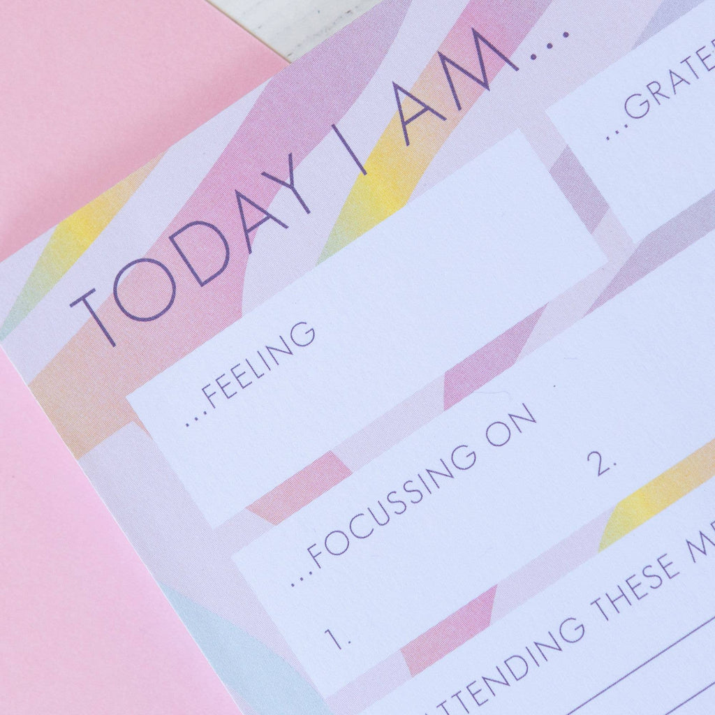 A close-up of a planner open on a desk, surrounded by colourful stationery, showing a bright and organized day ahead.