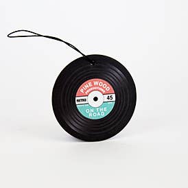 A car air freshener shaped like a vinyl record, suspended from a string, adding a decorative touch.