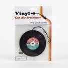 A car air freshener shaped like a vinyl record.