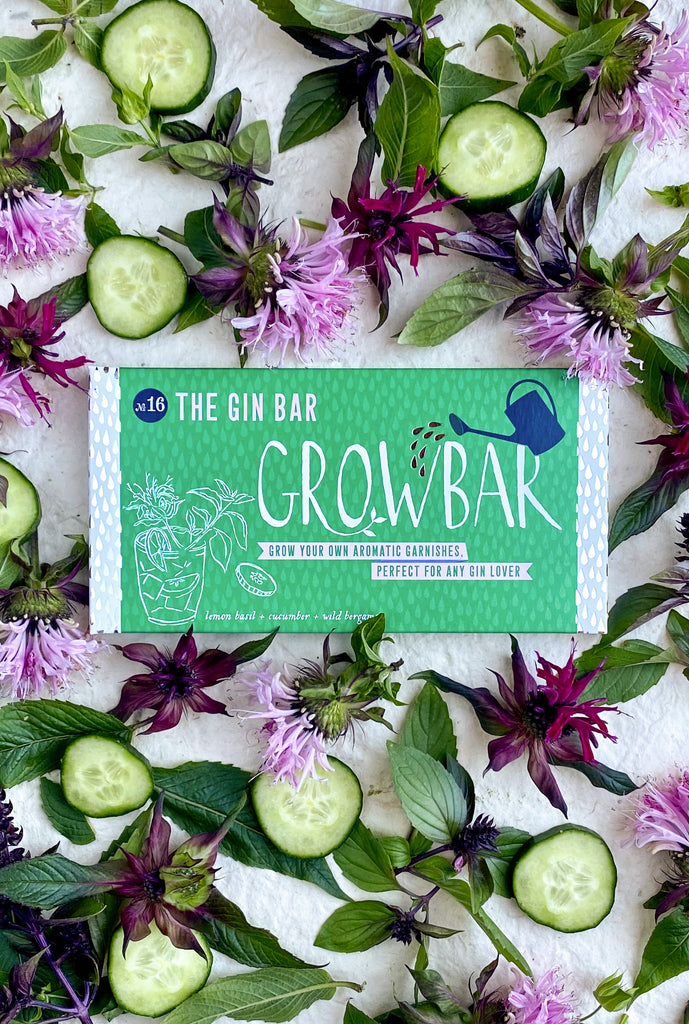 A stylish gin bar featuring a grow bar filled with fresh herbs, creating a lively and inviting atmosphere.