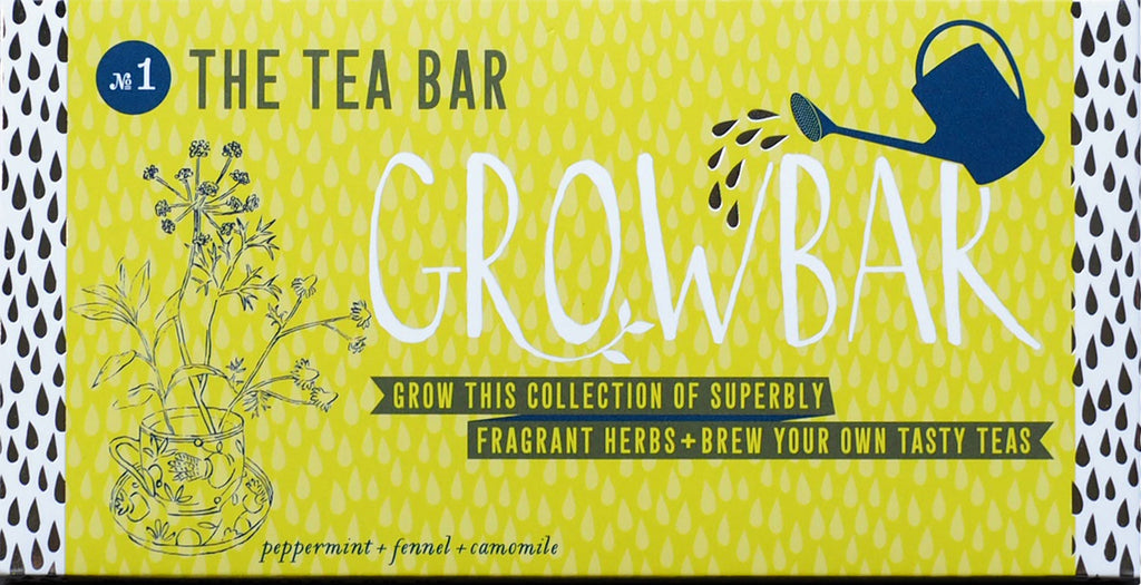 A colourful The Tea Bar Growbar yellow package with text, a watering can and herbal arrangement out of a tea cup illustration